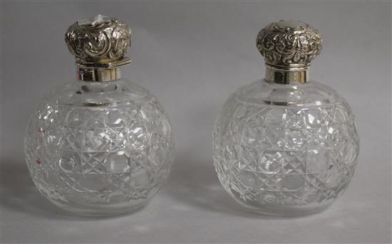 A pair of late Victorian silver mounted cut glass scent bottles, Chester, 1900, 13.5cm.